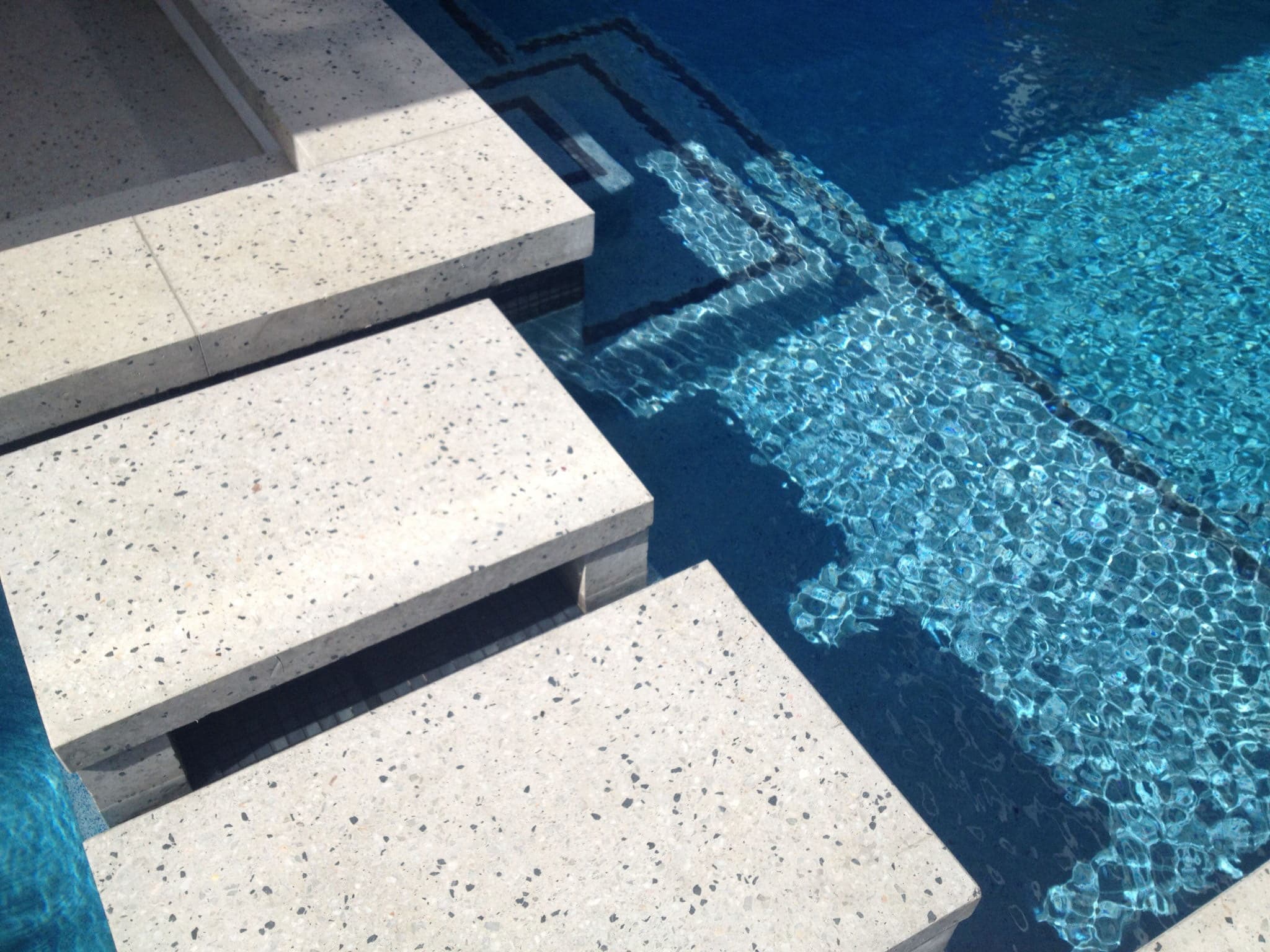 White concrete steps around pool - Mcginn concrete